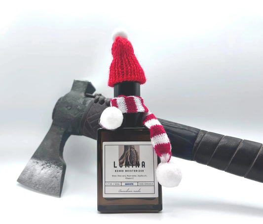 beard moisturizer with holiday knit hat and scarf in front of axe