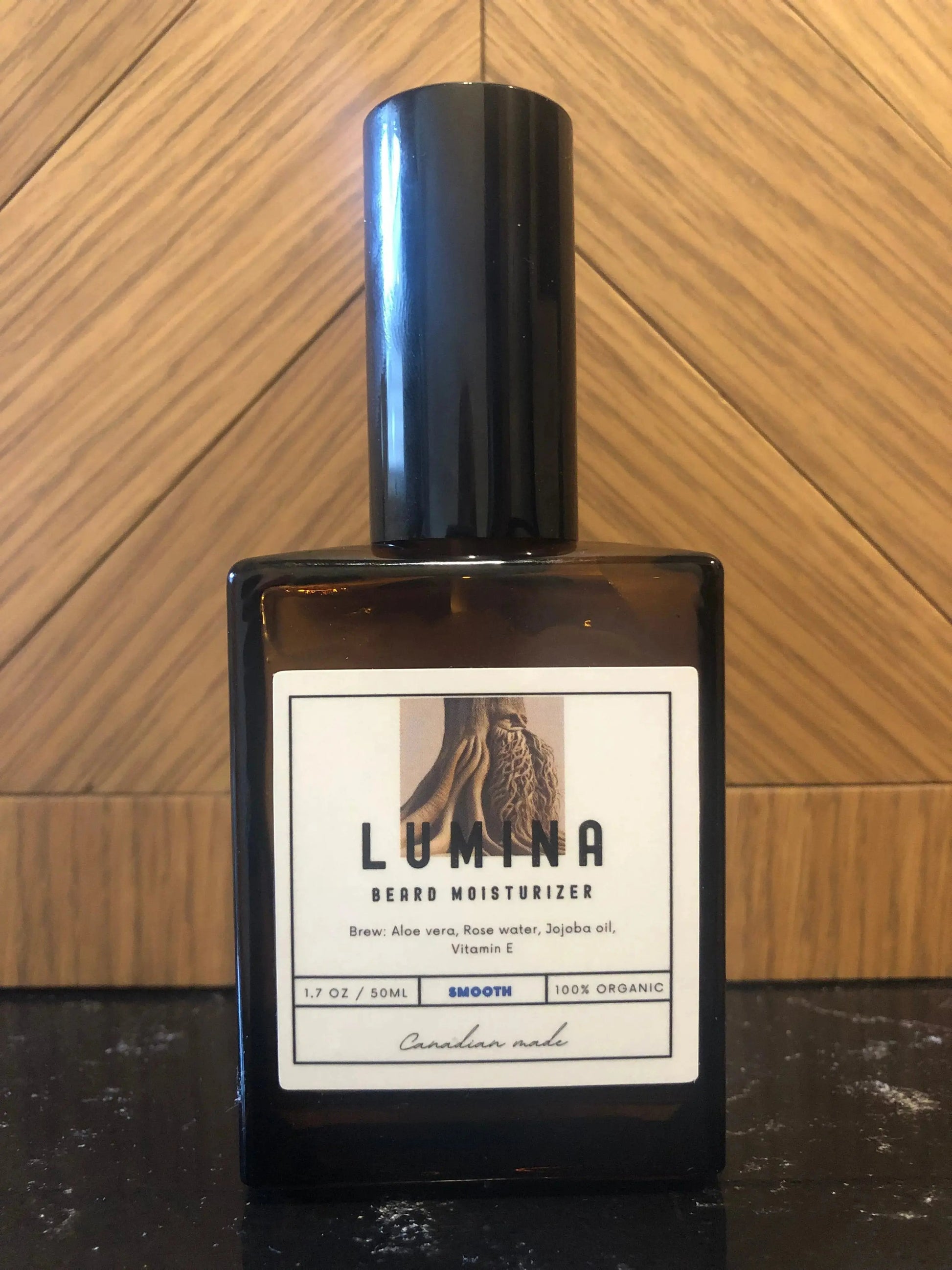 50ml pump bottle of beard moisturizer with a label showing the brand name LUMA and an image of a beard. The bottle is placed against a wooden background.