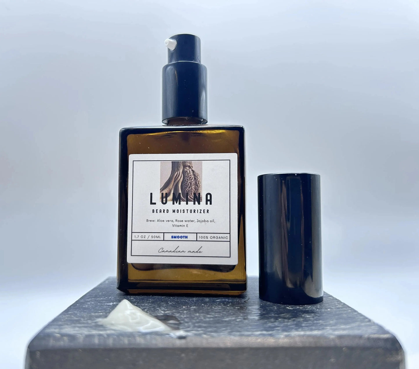 Lumina hair moisturizer bottle with pump on a gray surface